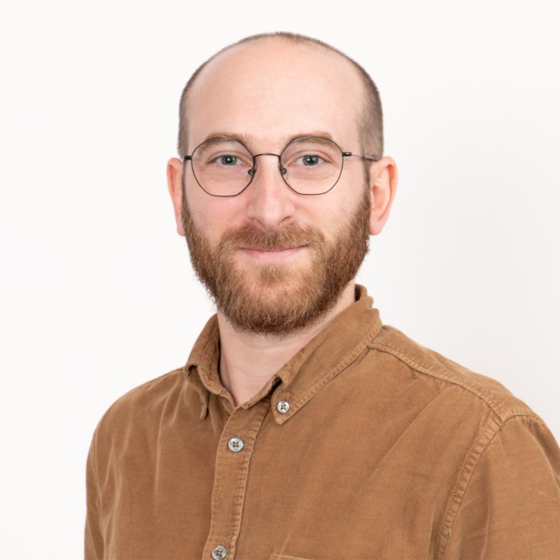 A image of a concrete sphere, balanced between two other larger spheres